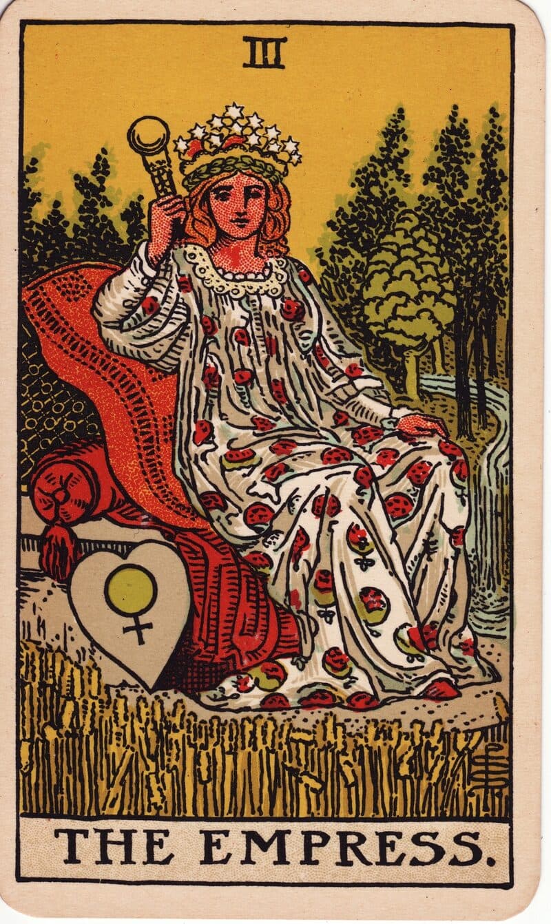 Carta de La Emperatriz — figura coronada en trono rodeada de trigo con escudo de Venus, baraja Rider-Waite-Smith